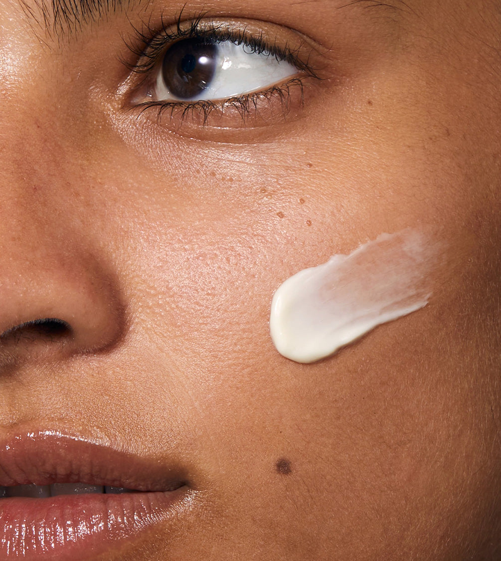 A tight shot featuring the model's facial close-up, showcasing the application of Cushioning Day Cream.