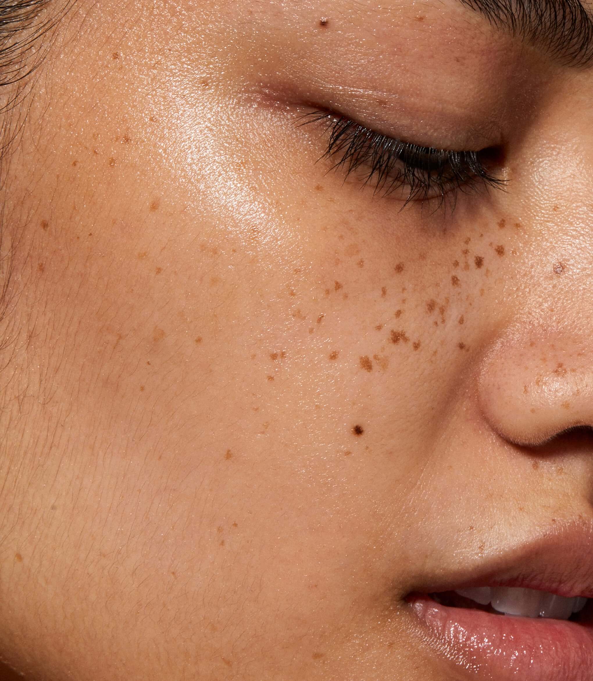 A close up of model's face with Oxygen Booster applied to her skin.