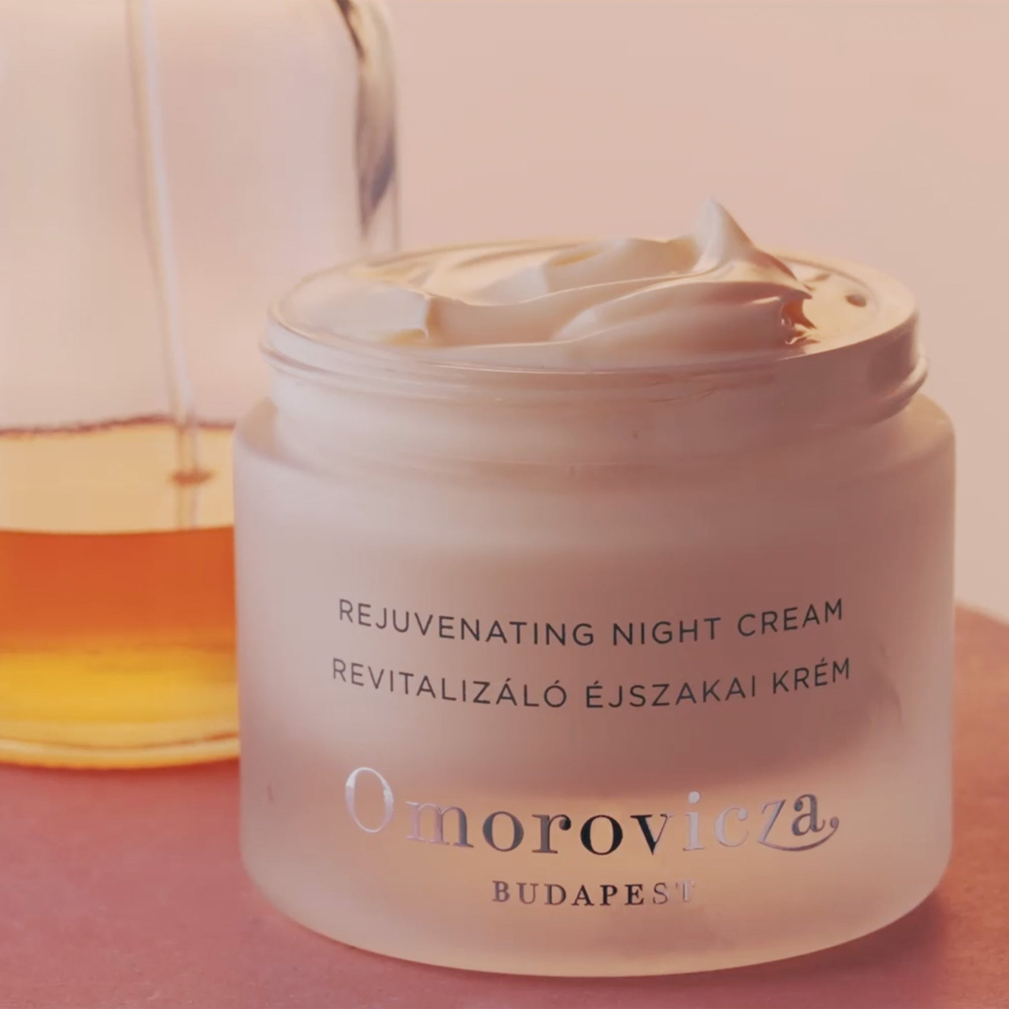 A close up of Rejuvenating Night Cream in an open jar, shows creamy and rich texture of the product