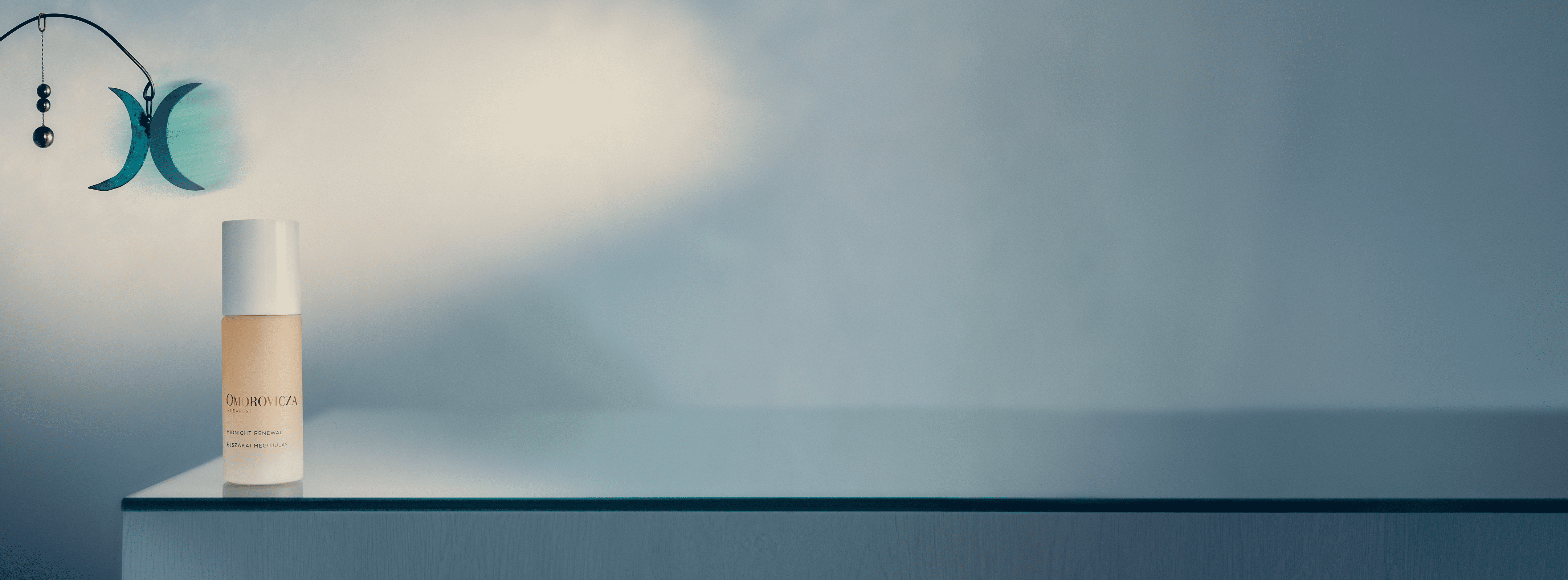 Omorovicza Midnight Renewal product banner showing the bottle and a mobile element on the back