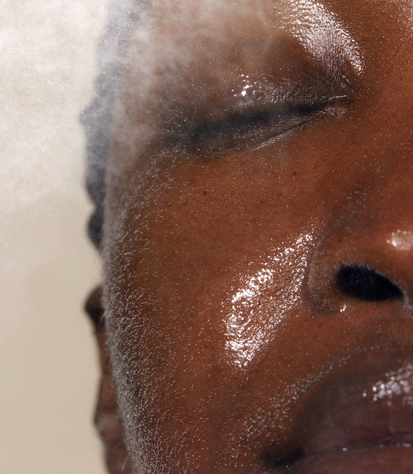 A close up of models face with Queen of Hungary Evening Mist applied to her face. The mist is designed to lock in essential moisture to protect and repair the skin while sleeping
