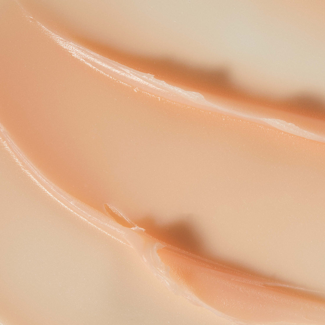 A close up of texture of Queen Cream. Luxurious creamy texture with a soft pink colour.