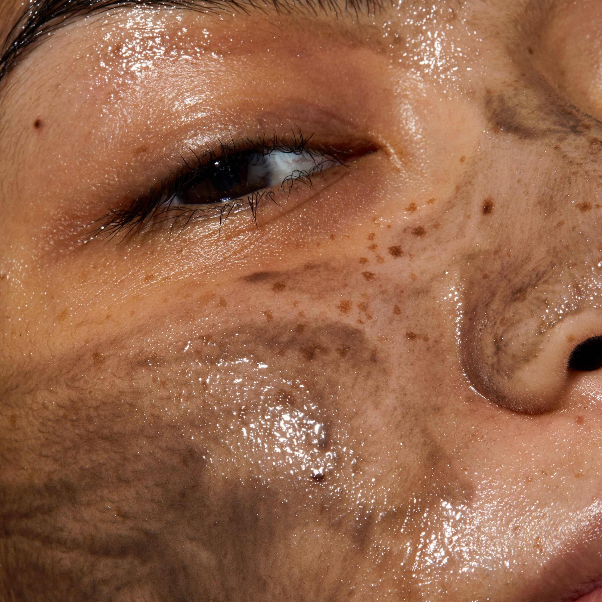 Close up of model's face with Thermal Cleansing Balm applied to her skin. The product has grey colour due to  Hungarian Moor Mud 